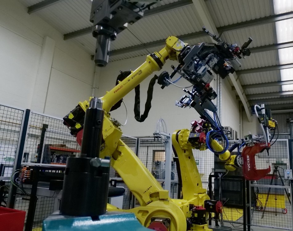 The two robots in cell 1, work in harmony feeding the respective fastening and riveting stations.