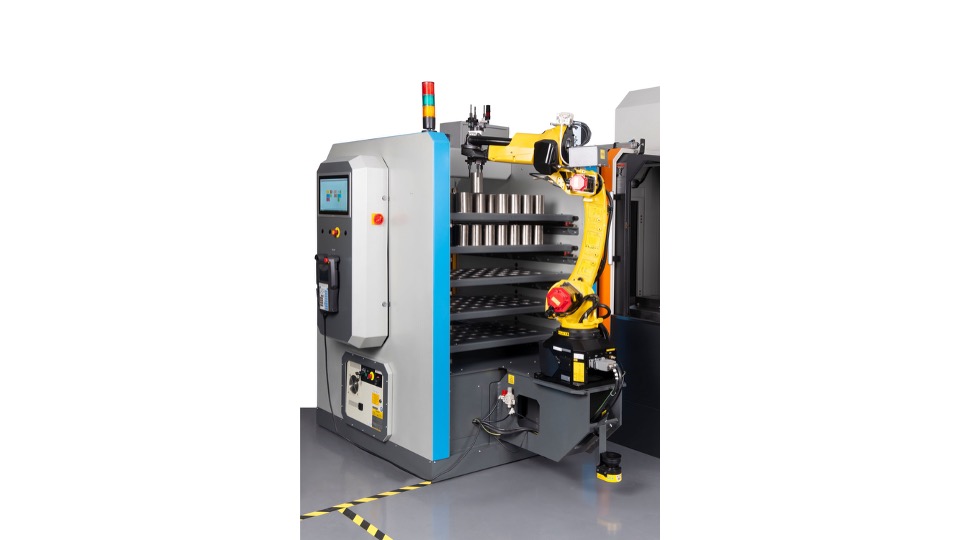Tezmaksan CubeBOX robotic automation system tending a CNC machine tool on a trade show exhibition stand