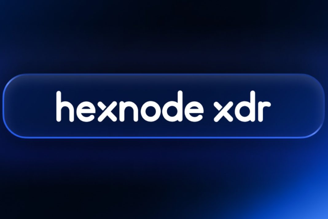 Hexnode XDR dashboard displaying threat detection alerts, asset scoring and automated remediation controls on a computer screen