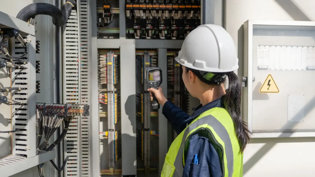 Industrial motor and electrical control panel in a manufacturing plant being monitored for power quality and predictive maintenance