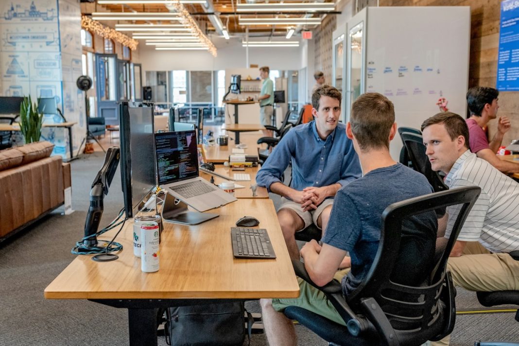 Business professional reviewing AI-generated research insights on a digital dashboard in a modern office environment
